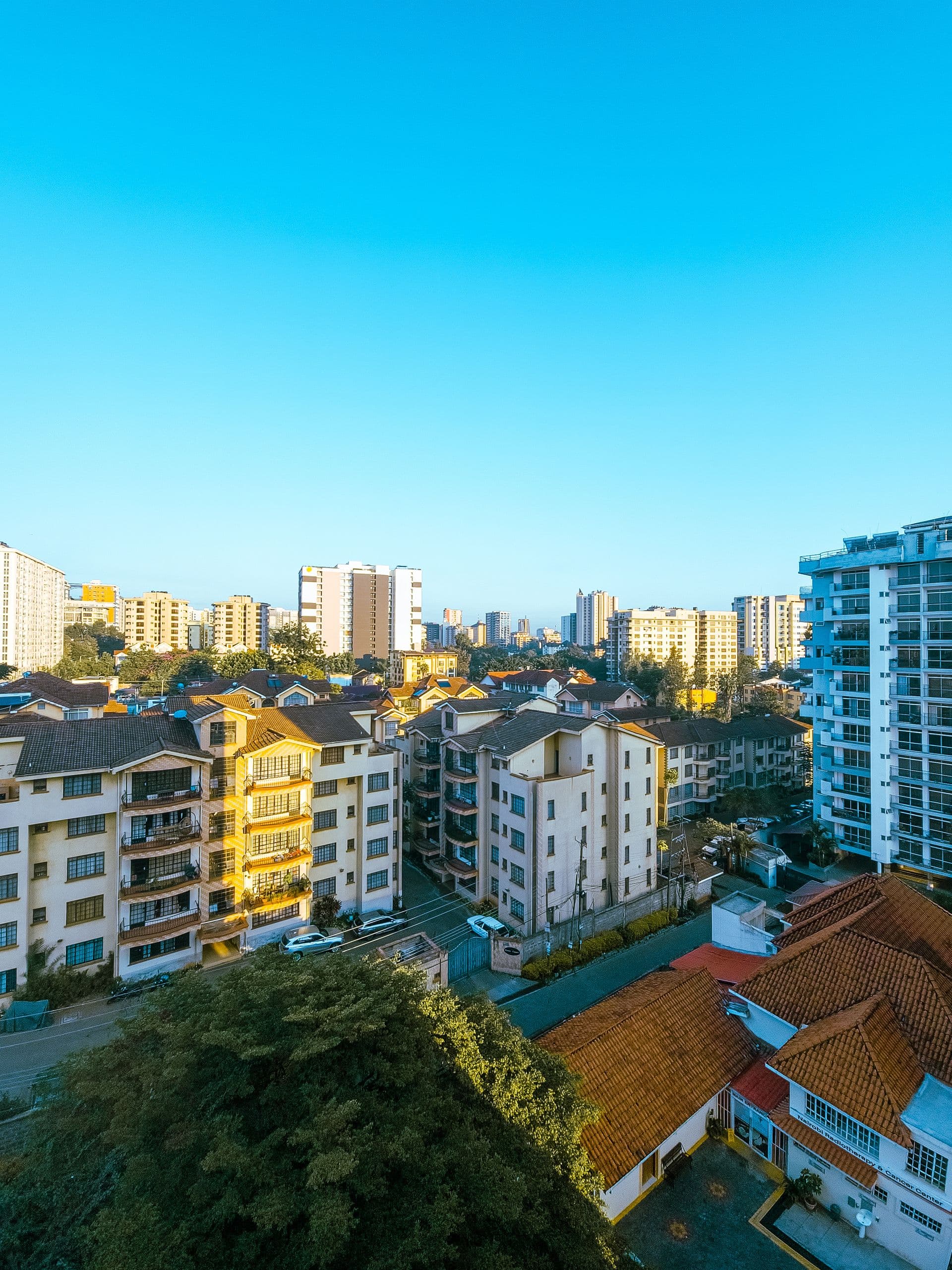 Aerial view of an upscale, leafy residential estate in Nairobi at golden hour